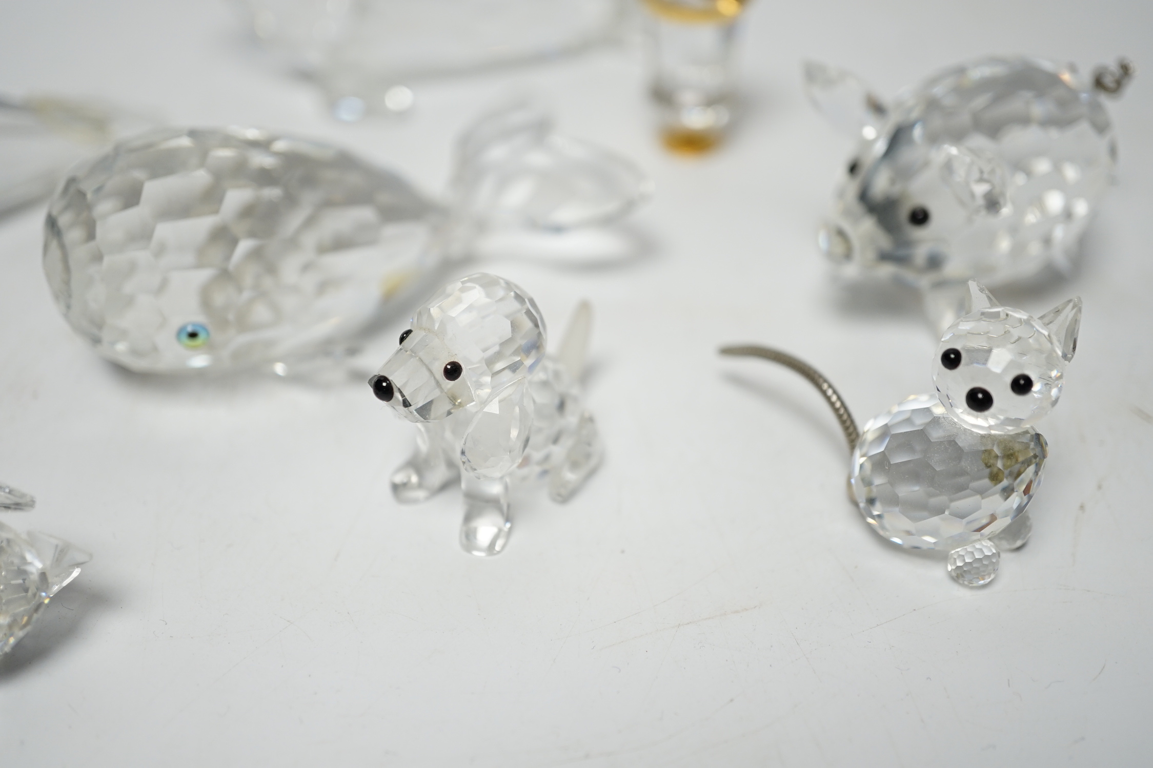 Eight Swarovski crystal animal ornaments and a miniature set of a Champagne cooler and two Champagne glass flutes, (11)